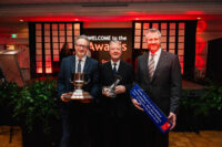 Image of three men holding their awards